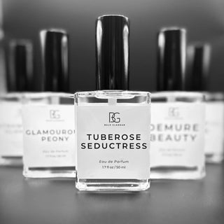 Luxurious Bald Glamour perfume bottle elegantly positioned on a reflective surface, emphasizing its sleek and sophisticated design. The image highlights the premium quality and refined aesthetic of the fragrance brand.